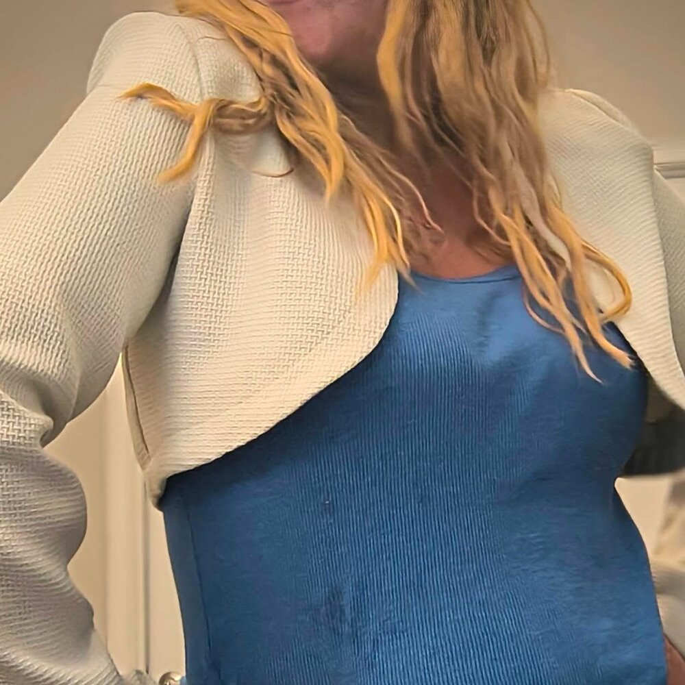 A medium cream-colored crop jacket by dazy. pebbled texture